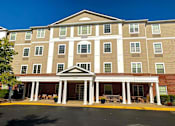 Thumbnail 3 of 15 - Exterior view of Park View at South Pantops, a senior apartment community in the Carriage Hill area near Charlottesville, featuring well-maintained buildings, landscaped grounds, and convenient on-site parking for adults age 62 and better.