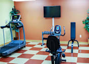 Thumbnail 5 of 15 - Community fitness center at Park View at South Pantops, equipped with senior-friendly exercise machines to support resident wellness, mobility, and active living in a welcoming environment.