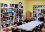 Thumbnail 6 of 15 - Well-stocked resident lending library at Park View at South Pantops, offering books, comfortable seating, and a quiet space for relaxation and lifelong learning in this 62+ senior community.