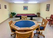 Thumbnail 8 of 15 - Resident game area at Park View at South Pantops featuring a card table and billiards table, offering seniors age 62+ a welcoming space for connection, recreation, and socializing with neighbors.