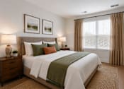 Thumbnail 17 of 18 - A bedroom with a large bed, two nightstands, and a window with curtains.