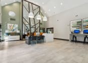 Thumbnail 2 of 26 - a lobby with a reception desk and a desk with a computer on it at The Hartley at Sweetwater Creek, Duluth, GA, 30096