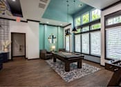 Thumbnail 13 of 36 - a game room with a pool table and large windows at Grand Oak at Town Park, Smyrna, 37167