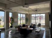 Thumbnail 4 of 55 - a large living room with couches and chairs and large windows