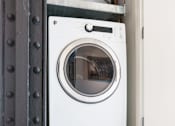Thumbnail 4 of 9 - Two white front loading washing machines stacked on top of each other.