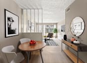 Thumbnail 8 of 10 - A modern dining room with a round table and chairs.