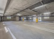Thumbnail 42 of 43 - A large, empty parking garage with concrete floors and walls.