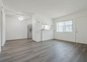 Thumbnail 13 of 35 - A spacious room with wooden flooring and white walls.