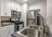 Thumbnail 3 of 14 - Kitchen with stainless steel sink and new appliances