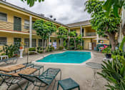 Thumbnail 4 of 15 - our apartments have a swimming pool and a patio with chairs