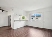 Thumbnail 14 of 35 - A room with white walls and a window overlooking a building.