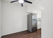 Thumbnail 11 of 35 - A kitchen with a stainless steel refrigerator and white cabinets.