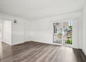 Thumbnail 16 of 35 - A room with a sliding glass door leading to a balcony.