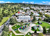 Thumbnail 14 of 14 - A playground with a slide and a red pin on a building.