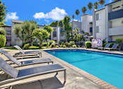 Thumbnail 20 of 23 - a swimming pool in front of an apartment building