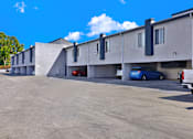 Thumbnail 19 of 23 - a large white motel building with cars parked in front of it
