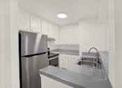 Thumbnail 15 of 23 - A modern kitchen with a stainless steel refrigerator and a sink with a faucet.