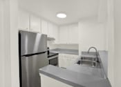 Thumbnail 22 of 23 - an empty kitchen with stainless steel appliances and white cabinets