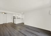 Thumbnail 12 of 23 - A room with a wooden floor and a ceiling fan.