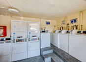Thumbnail 12 of 12 - A laundromat with washers and dryers.