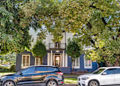 Thumbnail 1 of 14 - Two cars parked in front of a house.