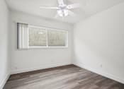 Thumbnail 19 of 35 - A room with a ceiling fan and a window with blinds.