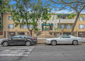 Thumbnail 1 of 19 - Two cars parked in front of a building with the number 7558 on it.