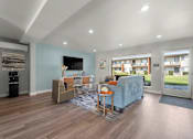 Thumbnail 57 of 64 - A living room with a blue couch and a television at Sunset Square, West Covina, 91790
