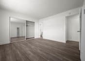 Thumbnail 49 of 64 - A large empty room with wooden floors and white walls at Sunset Square, West Covina, 91790