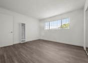 Thumbnail 43 of 64 - A room with a window and a door at Sunset Square, West Covina, 91790