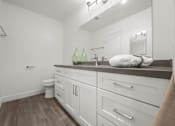 Thumbnail 54 of 64 - A bathroom with white cabinets and a white toilet at Sunset Square, West Covina, 91790