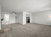 Thumbnail 21 of 64 - A spacious living room with a ceiling fan and a lamp at Sunset Square, West Covina, 91790