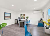 Thumbnail 13 of 55 - A modern room with a dining table and chairs.