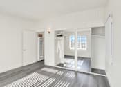 Thumbnail 23 of 55 - A room with a white door and a mirror on the wall.