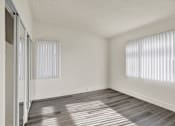 Thumbnail 25 of 55 - A room with a sliding door and a window with blinds.