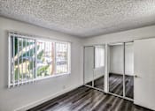 Thumbnail 20 of 55 - Bedroom view with mirrored closet doors at Serrano Apartments, West Covina, CA, 91790
