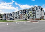 Thumbnail 14 of 45 - a large parking lot with an apartment building in the background in Asheville NC