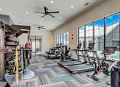 Thumbnail 15 of 45 - a spacious fitness room with cardio equipment and large windows in Asheville NC