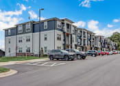 Thumbnail 8 of 45 - a row of apartment buildings with cars parked in front of them in Asheville
