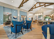 Thumbnail 5 of 32 - A room with blue chairs and wooden floors.