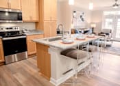 Thumbnail 3 of 18 - Kitchen island with barstool seating space