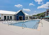 Thumbnail 24 of 45 - a swimming pool with a blue building in the background in Asheville NC