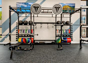 Thumbnail 13 of 32 - A gym with a weight rack and a bench.