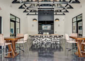 Thumbnail 9 of 45 - a large room with tables and chairs and a kitchen in the background in Asheville