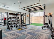 Thumbnail 7 of 45 - a home gym with weights and a punching bag in Asheville
