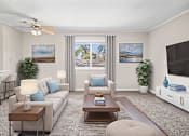 Thumbnail 1 of 10 - A living room with a white couch, a coffee table, a ceiling fan, and two potted plants.