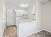 Thumbnail 16 of 20 - A kitchen with white cabinets and a countertop.