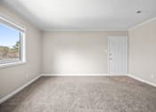 Thumbnail 14 of 20 - A room with a carpeted floor and a white door.