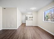 Thumbnail 1 of 20 - A kitchen area with wood flooring and white walls.