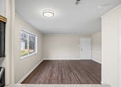 Thumbnail 3 of 20 - A room with a white ceiling and wooden flooring.